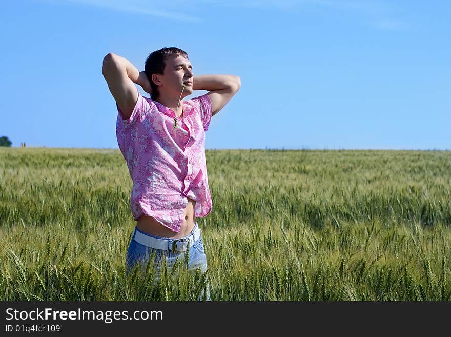 The man in the field relaxes. The man in the field relaxes