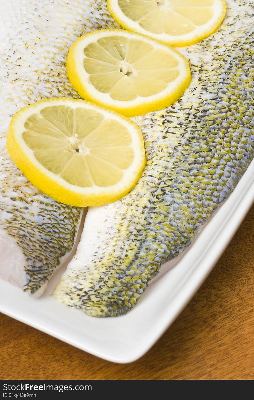 Raw Pickerel Fish Fillets With Sliced Lemon