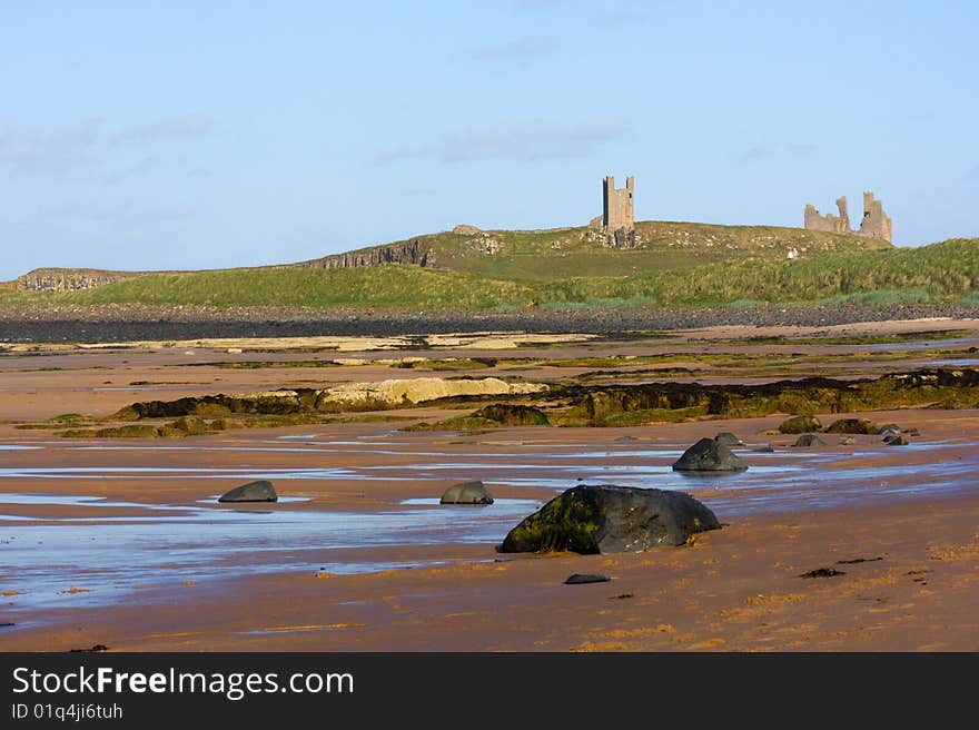 The magnificent coastline of Northumberland, featuring beach, rocks and ruined building. The magnificent coastline of Northumberland, featuring beach, rocks and ruined building