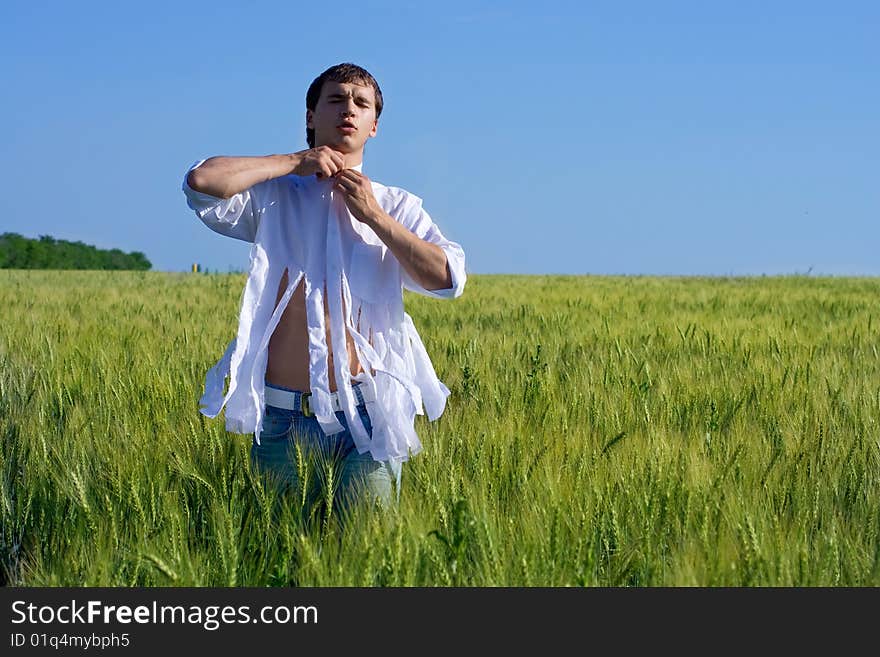 The man in the field relaxes. The man in the field relaxes