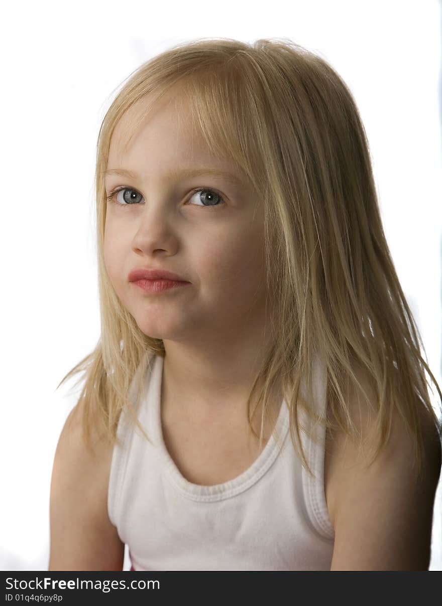 Grumpy child frowning against a white background