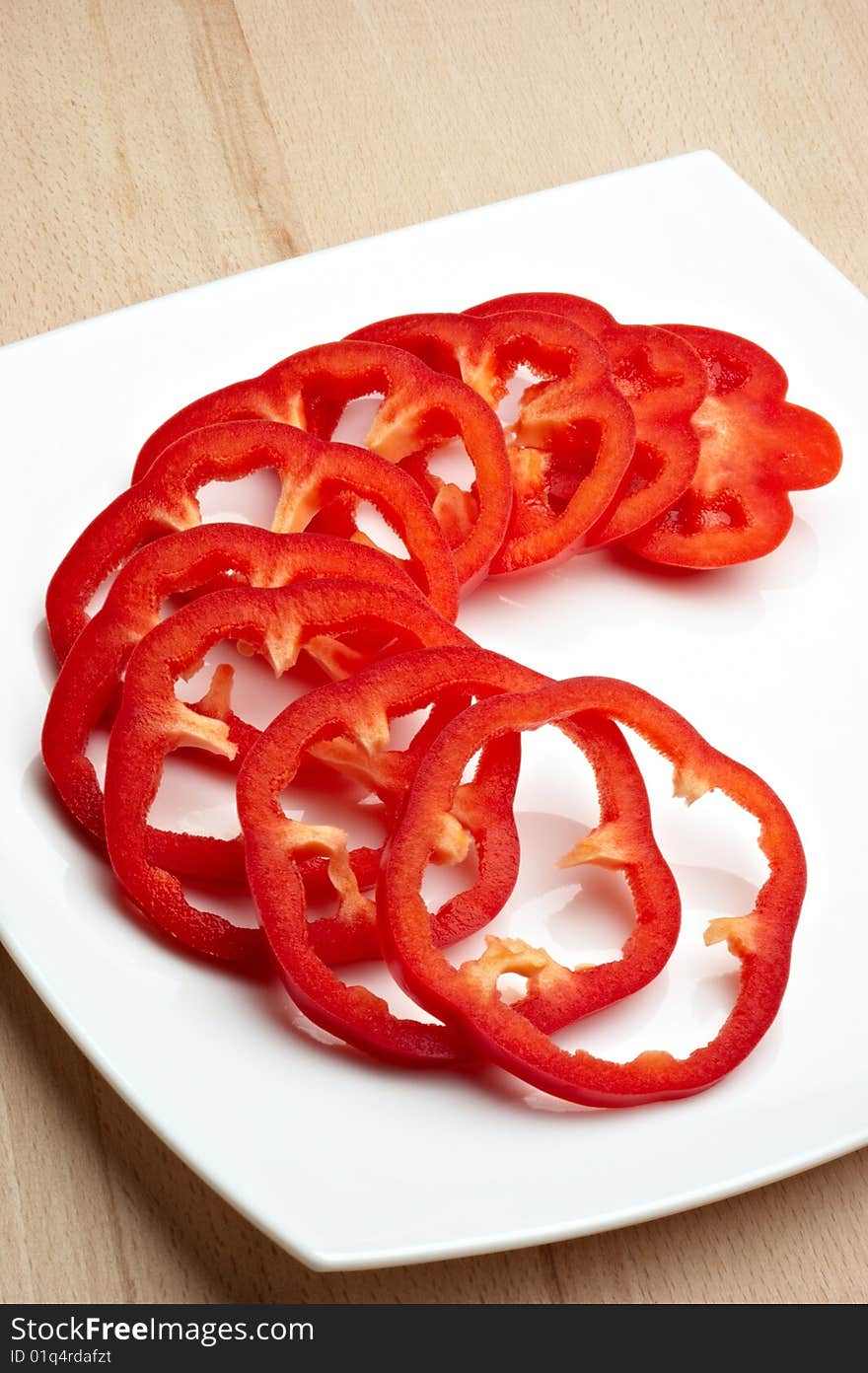 Sliced red pepper on white plate. Sliced red pepper on white plate