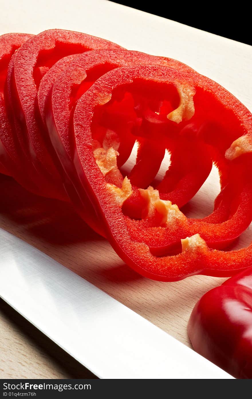 Sliced red pepper on cutting board with knife. Sliced red pepper on cutting board with knife