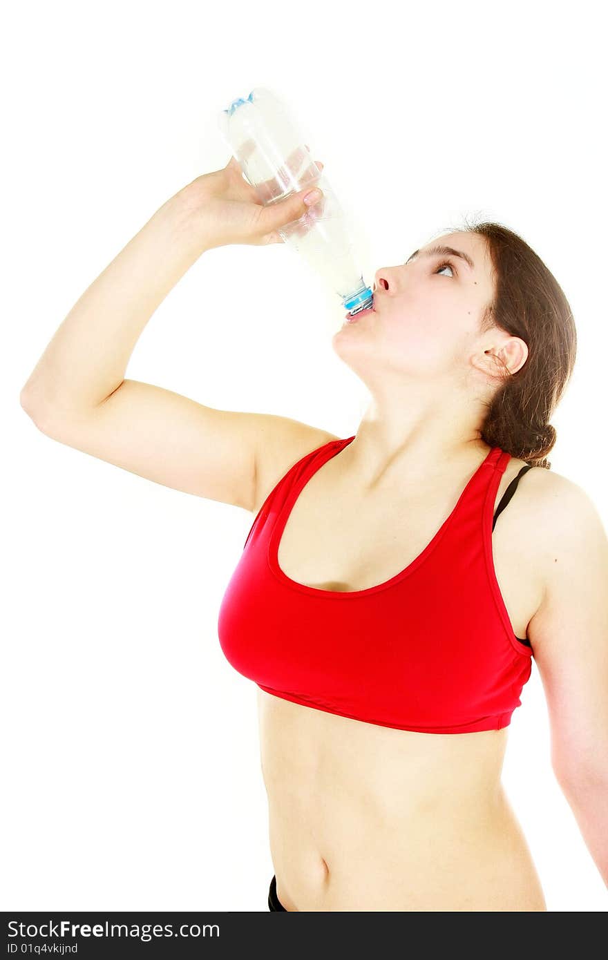 Young attractive girl drinking water over white