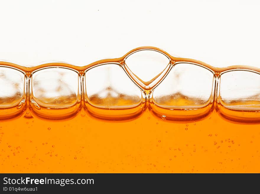 Macro of orange bubbles against white background