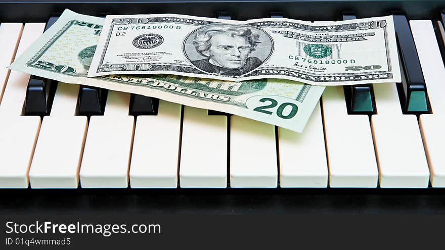 Two twenty dollar bills on electric organ keyboard