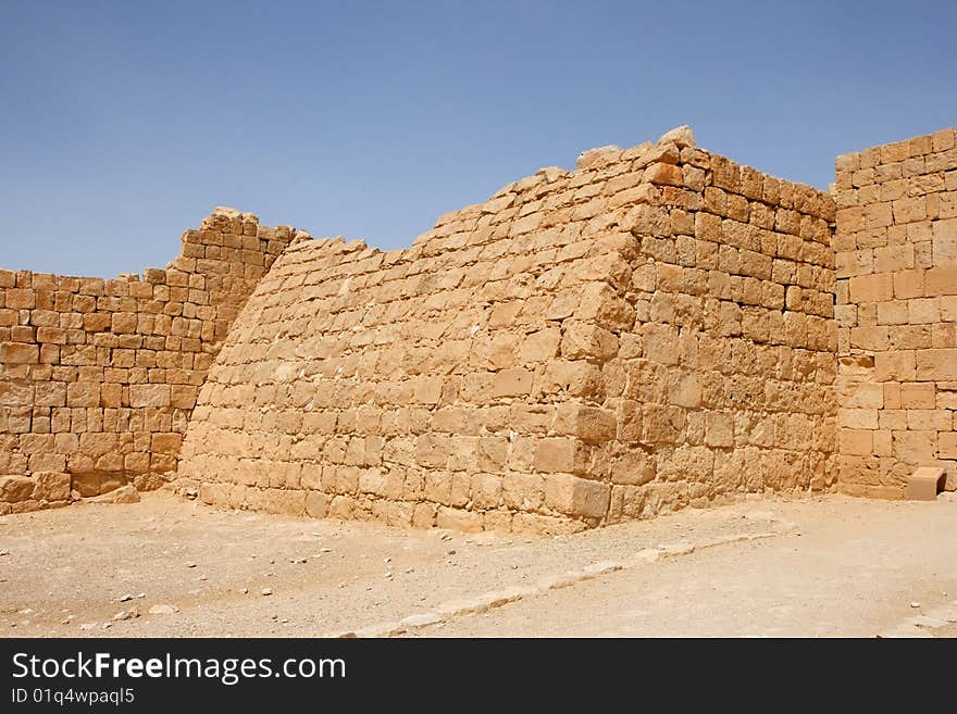 Ruins of the curved wall of ancient fortress in Ovdat, Israel