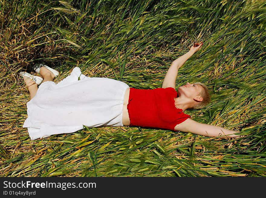 Young attractive girl resting in field