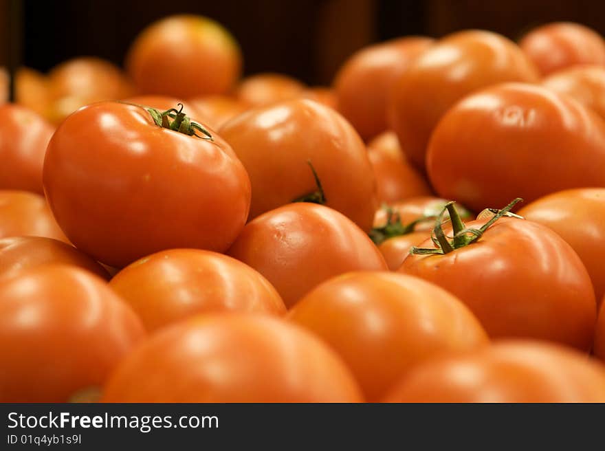 Group of Tomatoes shiny and red  with stems