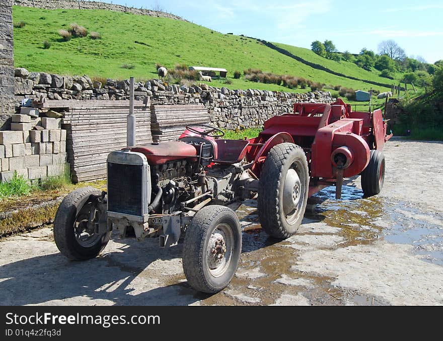 Close-up of old tractor in farm yard on sunny day