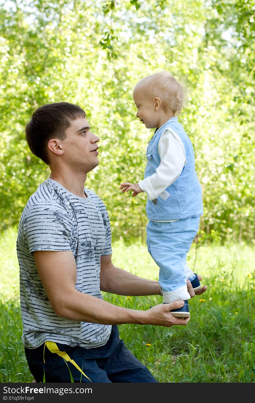 Father and son making acrobatics together. Father and son making acrobatics together