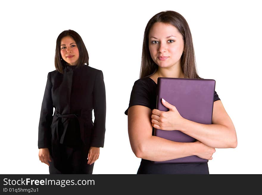 Two beautiful young businesswomen is standing. They are confident and energetic.