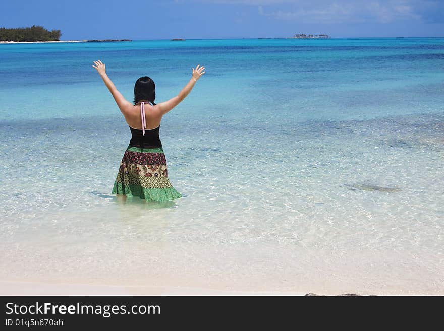 A woman stands in awe of the beautiful Caribbean Ocean and surroundings. Ahhh, this is beautiful, take me on vacation!. A woman stands in awe of the beautiful Caribbean Ocean and surroundings. Ahhh, this is beautiful, take me on vacation!