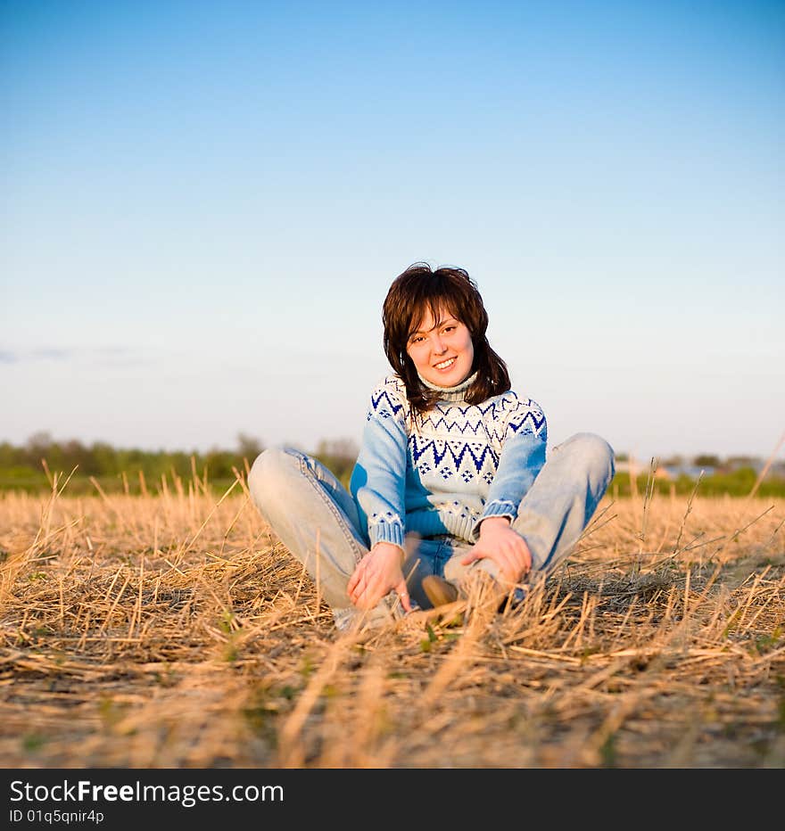 Smiling girl portrait outdoors with a field in the background