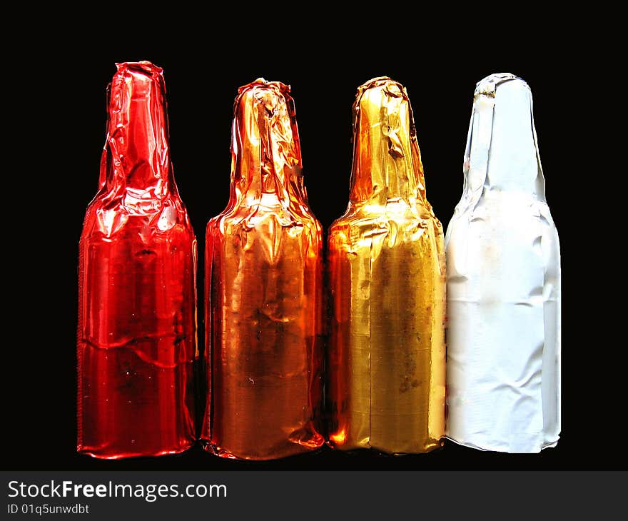 Four liquor chocolates shaped as bottles arranged in a row