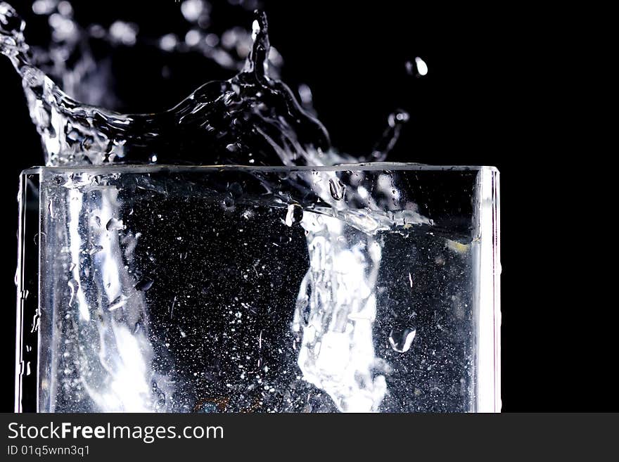 Water drops flow into glass