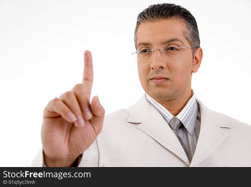 Side view of smiling businessman looking his finger on white background