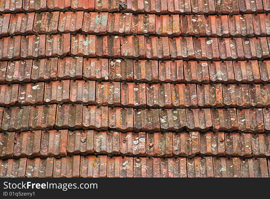 Background of old grungy roof tiles with moss