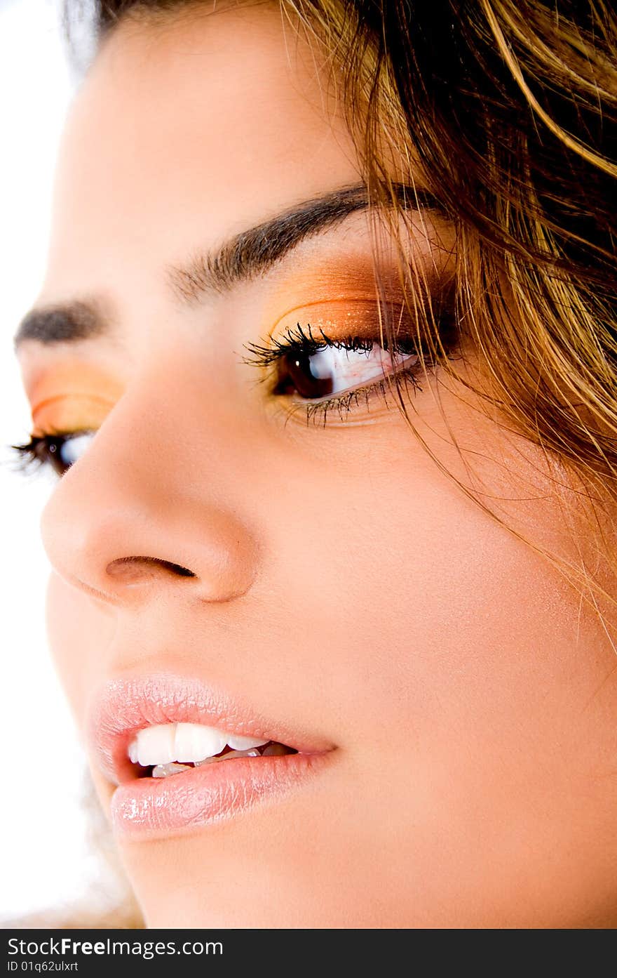 Close up of woman's face looking down on white background