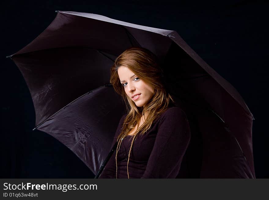 Portrait of smiling female holding umbrella