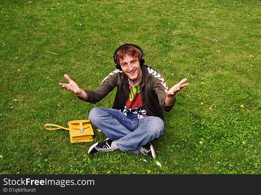 Young man sitting on the grass. Young man sitting on the grass