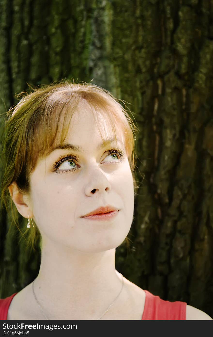 Young girl in the shade of large tree. Young girl in the shade of large tree