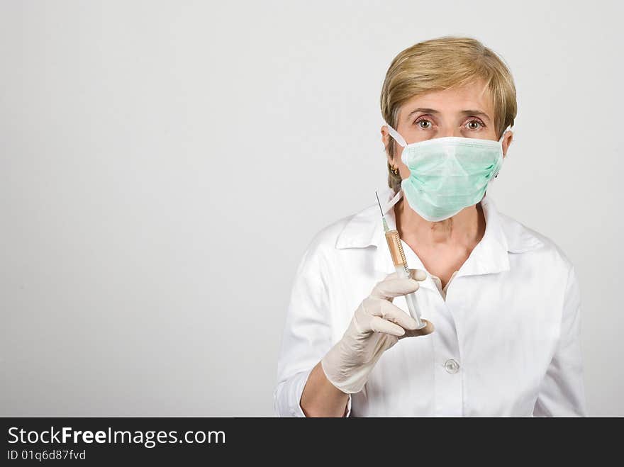 Senior woman doctor holding a syringe ,copy space for text message in left part of image,check also  <a href=http://www.dreamstime.com/medical-rcollection8351-resi828293>Medical</a>. Senior woman doctor holding a syringe ,copy space for text message in left part of image,check also  <a href=http://www.dreamstime.com/medical-rcollection8351-resi828293>Medical</a>