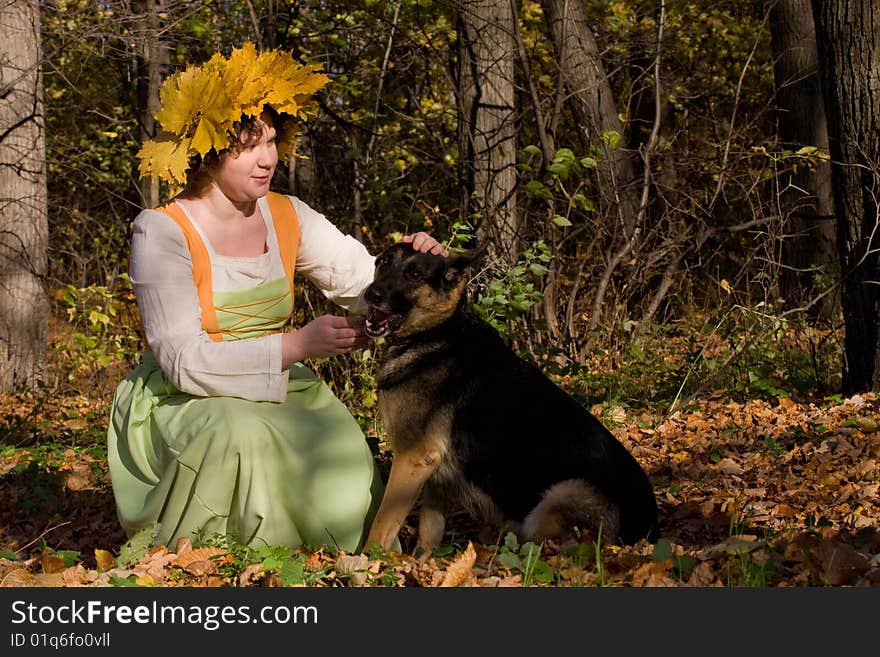 Woman and dog in autumn forest