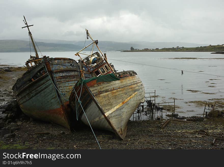 Ship wrecks at low tide by the Scottish coastline