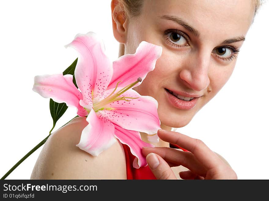 A portrait of a nice girl in red with a pink lily near her face on a white background. A portrait of a nice girl in red with a pink lily near her face on a white background