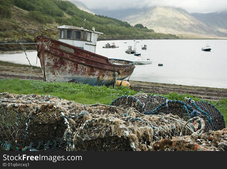 Fishing vessel and creels on shore of lake Slapin, Scotland. Fishing vessel and creels on shore of lake Slapin, Scotland