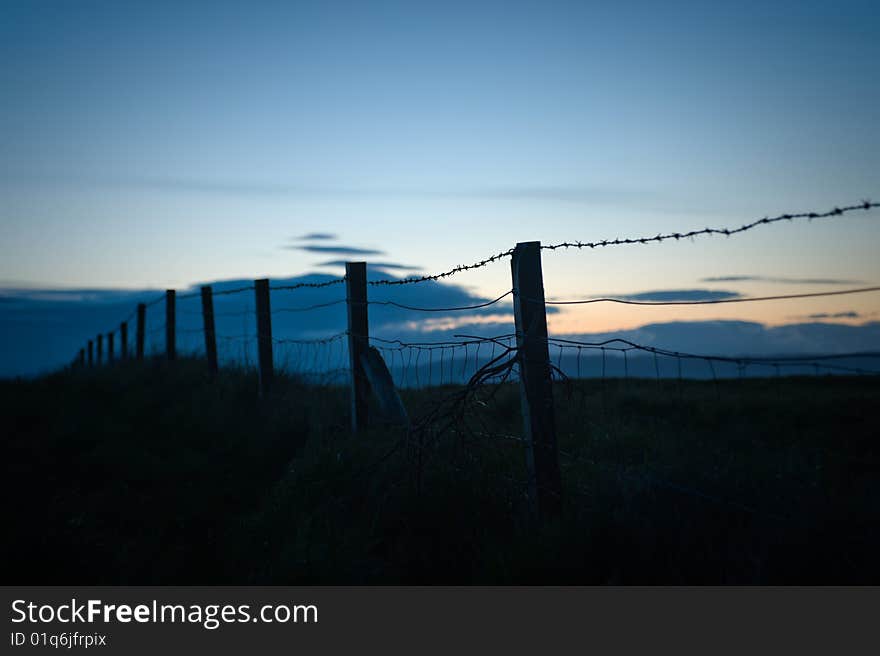 Low key image of a fence near Arisaig, Scotland. Low key image of a fence near Arisaig, Scotland