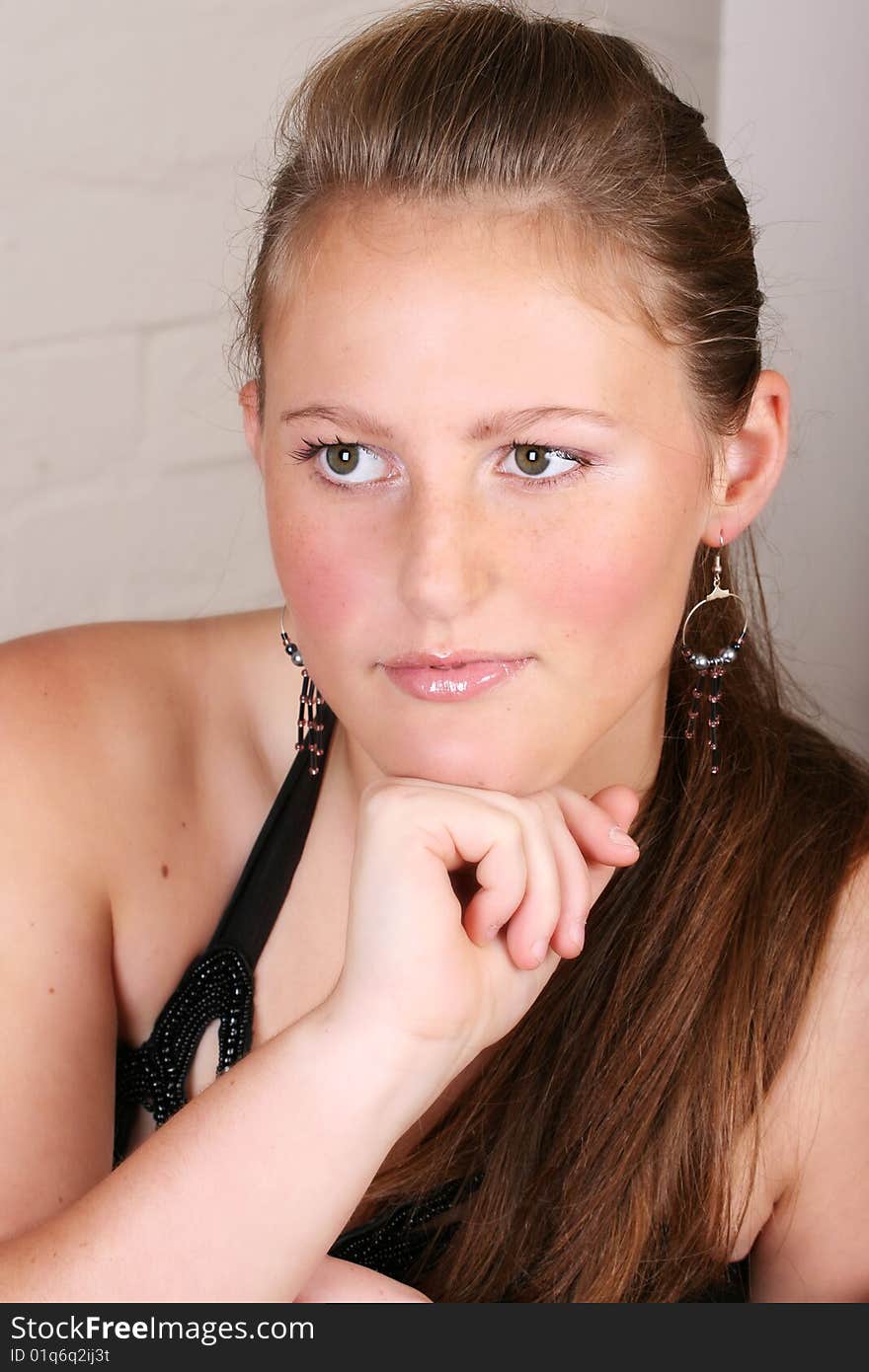 Close up of female teenager against a brick wall. Close up of female teenager against a brick wall