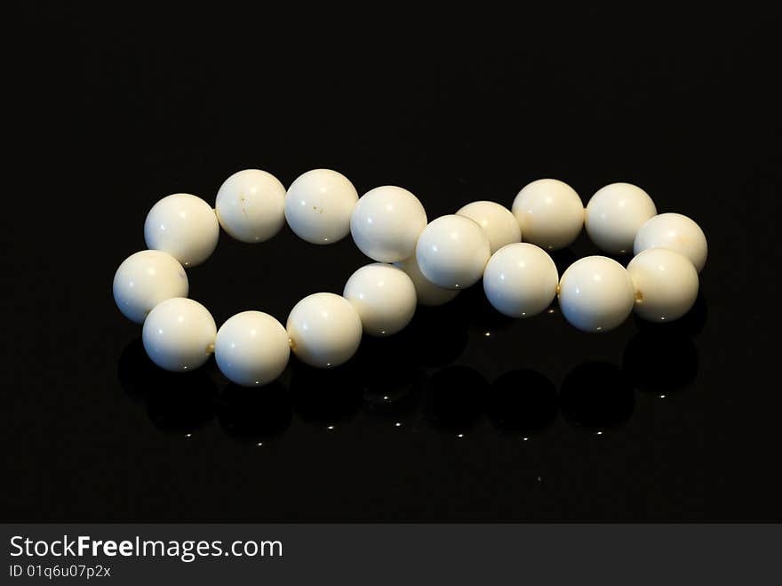 A set of jewelry consisting of a pearl pearl bracelet, isolated on black background