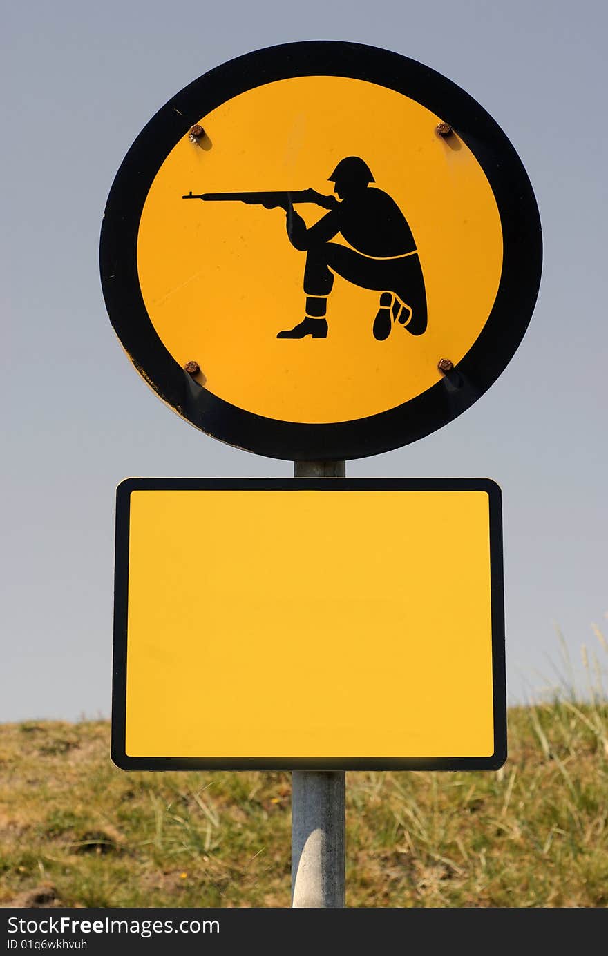 Shooting soldier sign. Add text on yellow blank sign. Warning sign near Danish shooting area.