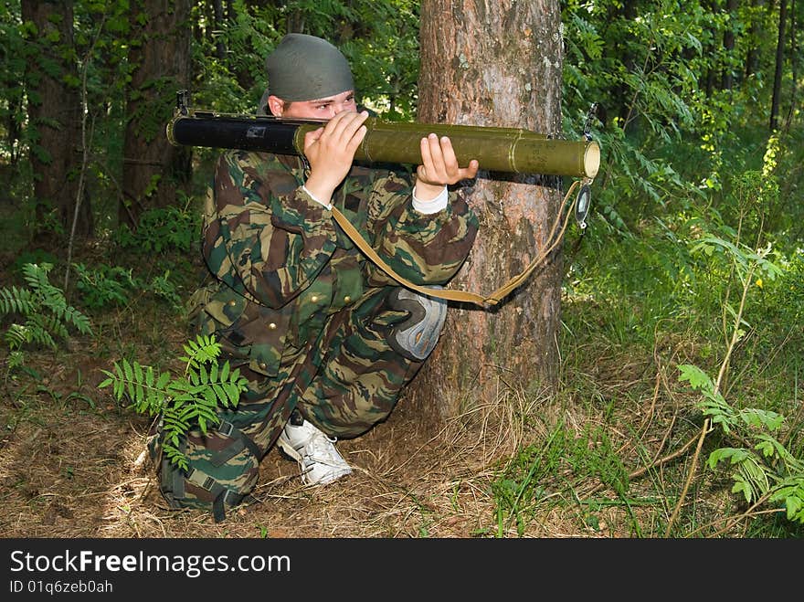 Man In A Camouflage Shoots From A Grenade Launcher