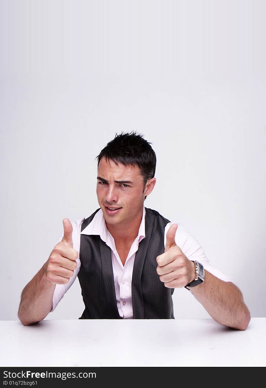 A handsome businessman with thumbs up on an isolated white background