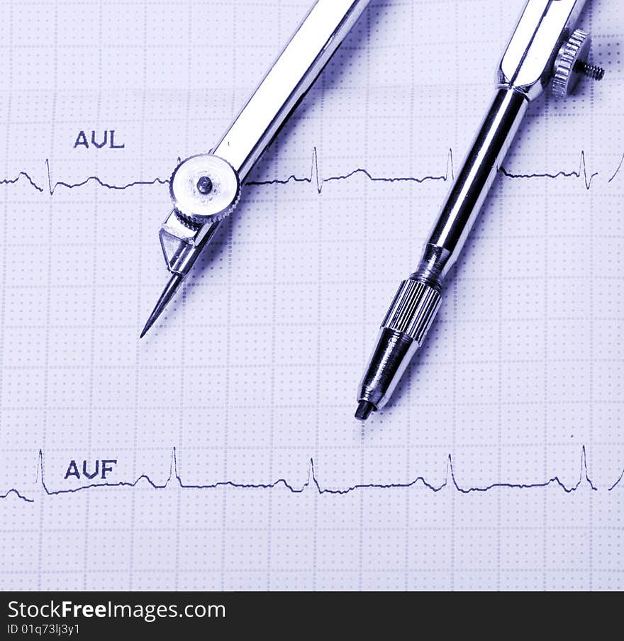 EKG printout and compasses under  monochromatic source