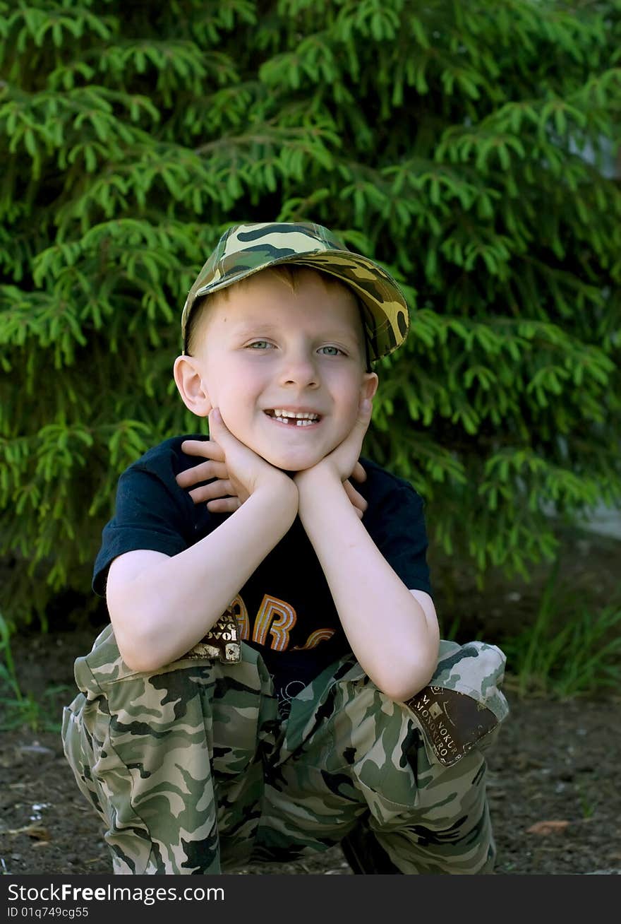 Photo of an adorable happy boy in the park