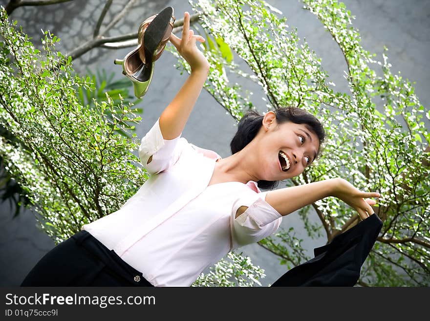 Conceptual portrait of pretty asian businesswoman in outdoors, seems excited after quitting from a stressful office job. Conceptual portrait of pretty asian businesswoman in outdoors, seems excited after quitting from a stressful office job