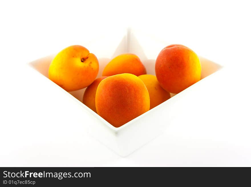 Bowl of apricots on a white background with clipping path