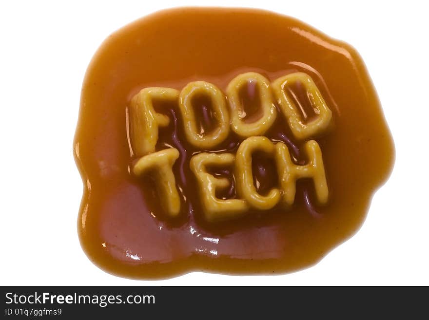 The words food tech spelled out in alphabet spaghetti pasta shapes, with tomato sauce, isolated on a white background. The words food tech spelled out in alphabet spaghetti pasta shapes, with tomato sauce, isolated on a white background.