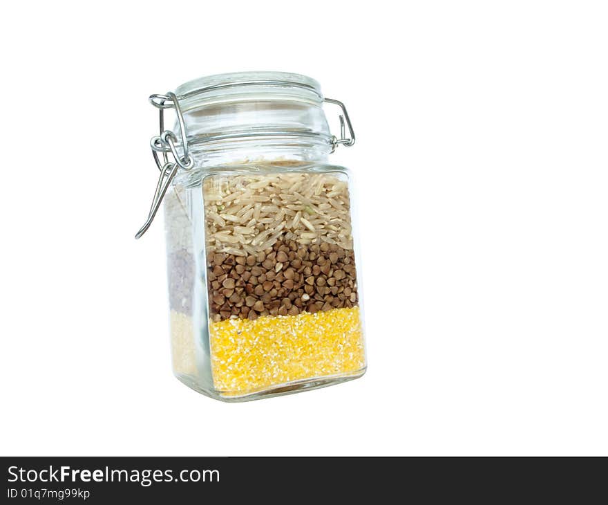 A jar with several kinds of cereal. A jar with several kinds of cereal