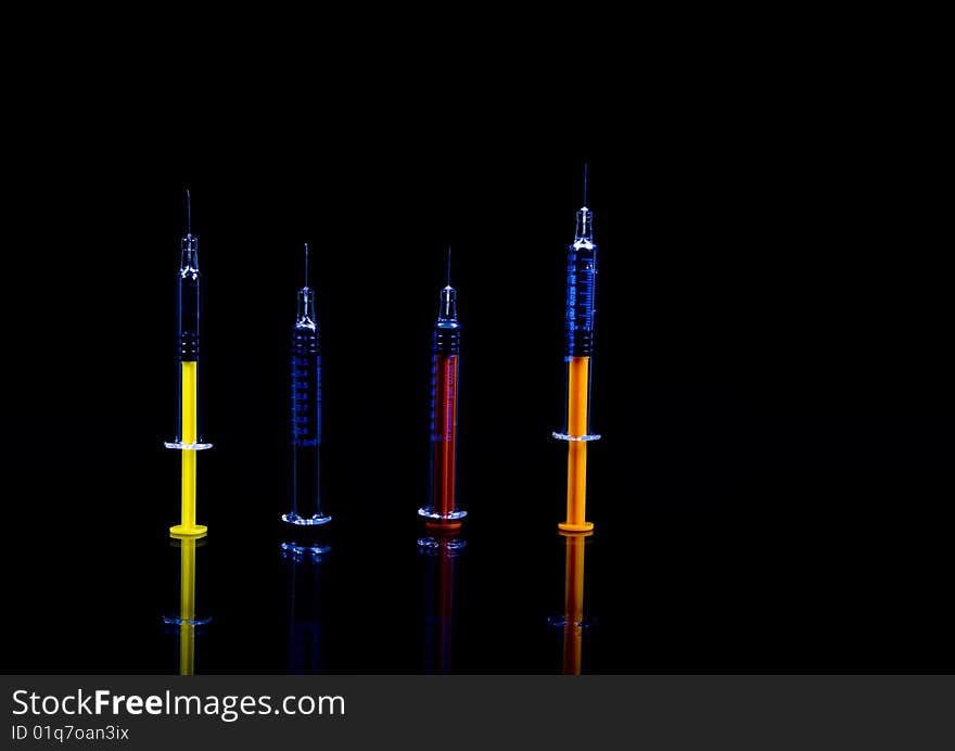 Color syringe on black background