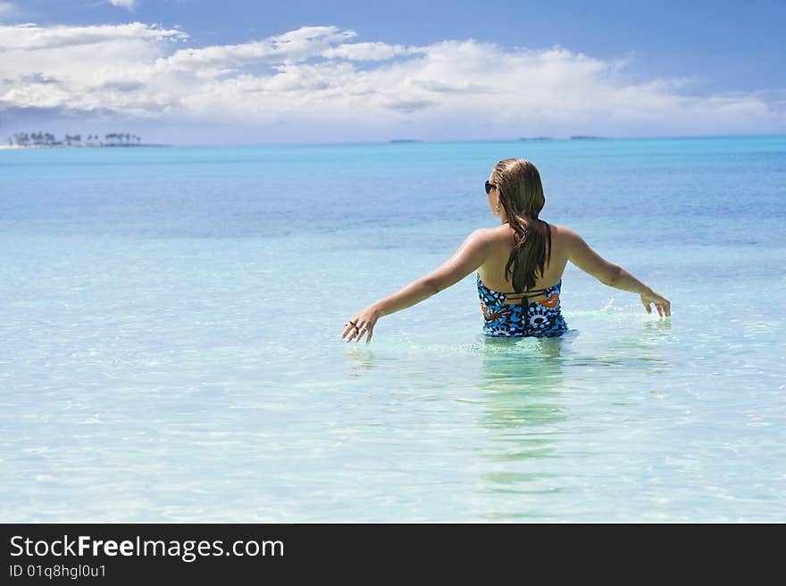 A woman walks through the warm Caribbean Ocean. Ahhh, this is beautiful, take me on vacation!. A woman walks through the warm Caribbean Ocean. Ahhh, this is beautiful, take me on vacation!