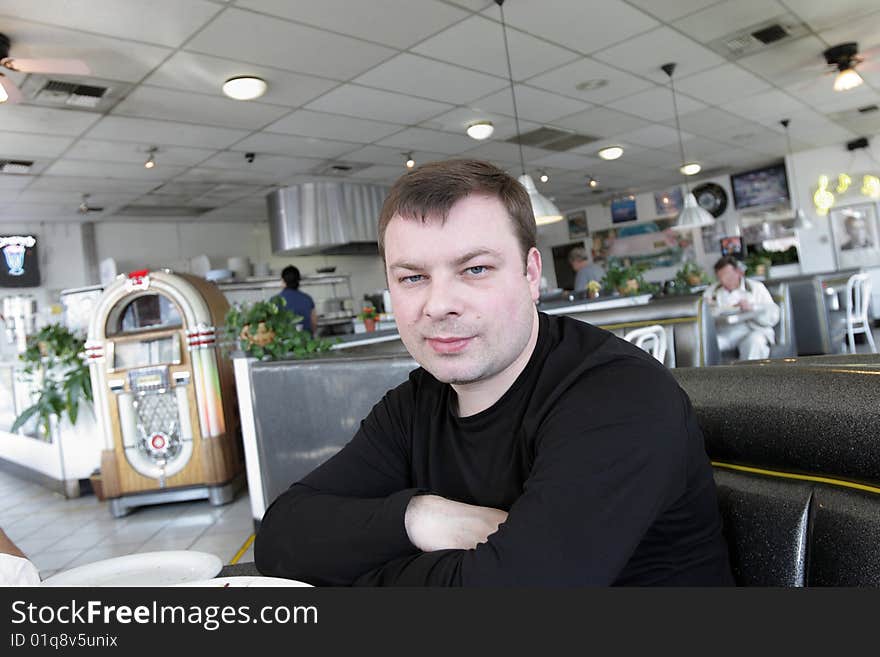 The man waits a breakfast in american snack bar