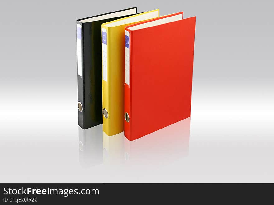 Three business folders on Gray background. Black, yellow and red colors. File with paths.