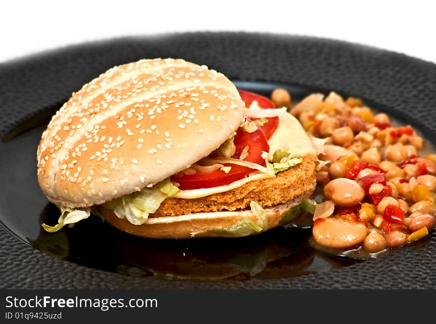 Chicken burger with bean sallad on plate