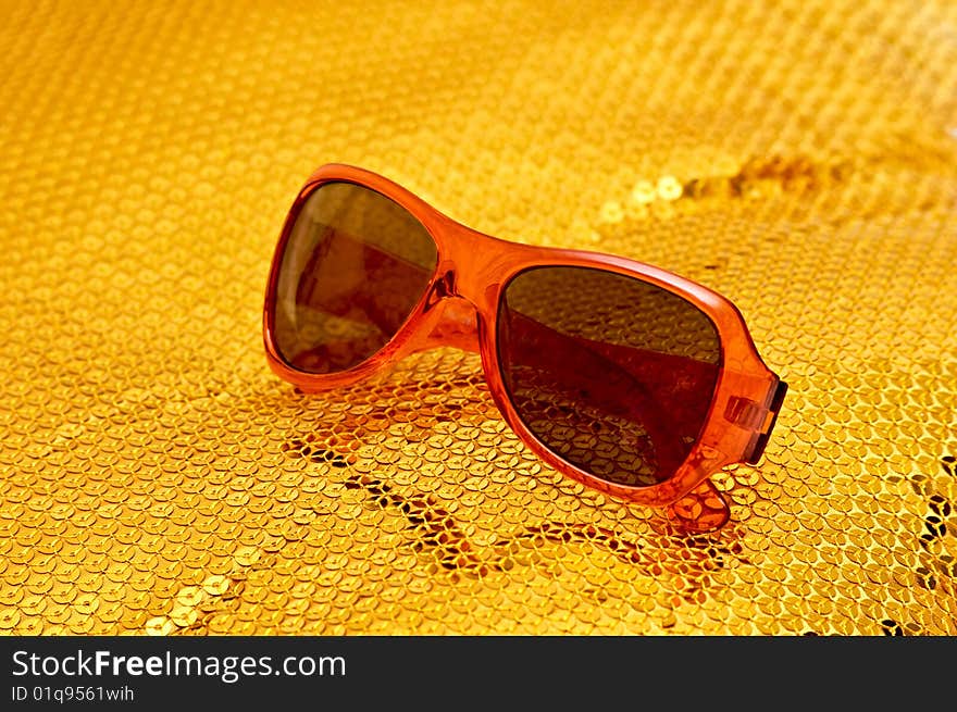 Photo of fashion sunglasses on sparkling pattern