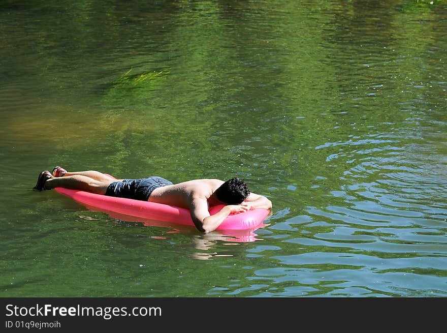 Man on an inflatable on river. Man on an inflatable on river